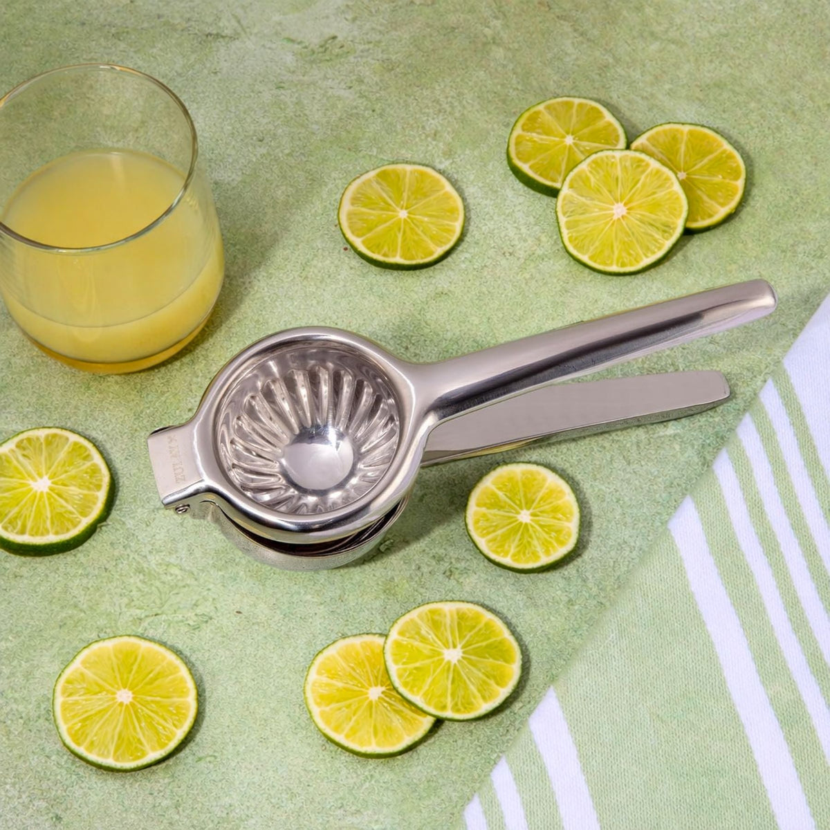 Zulay Kitchen Stainless Steel Lemon Squeezer with sliced lemons on a green surface